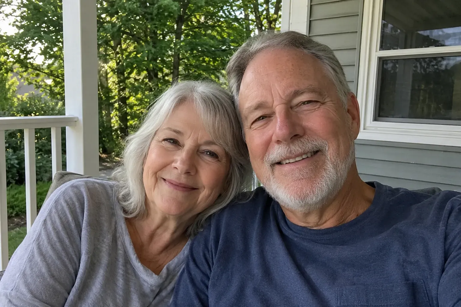 Review photo: an older couple smiling together, looking rested and relaxed on a porch in the morning