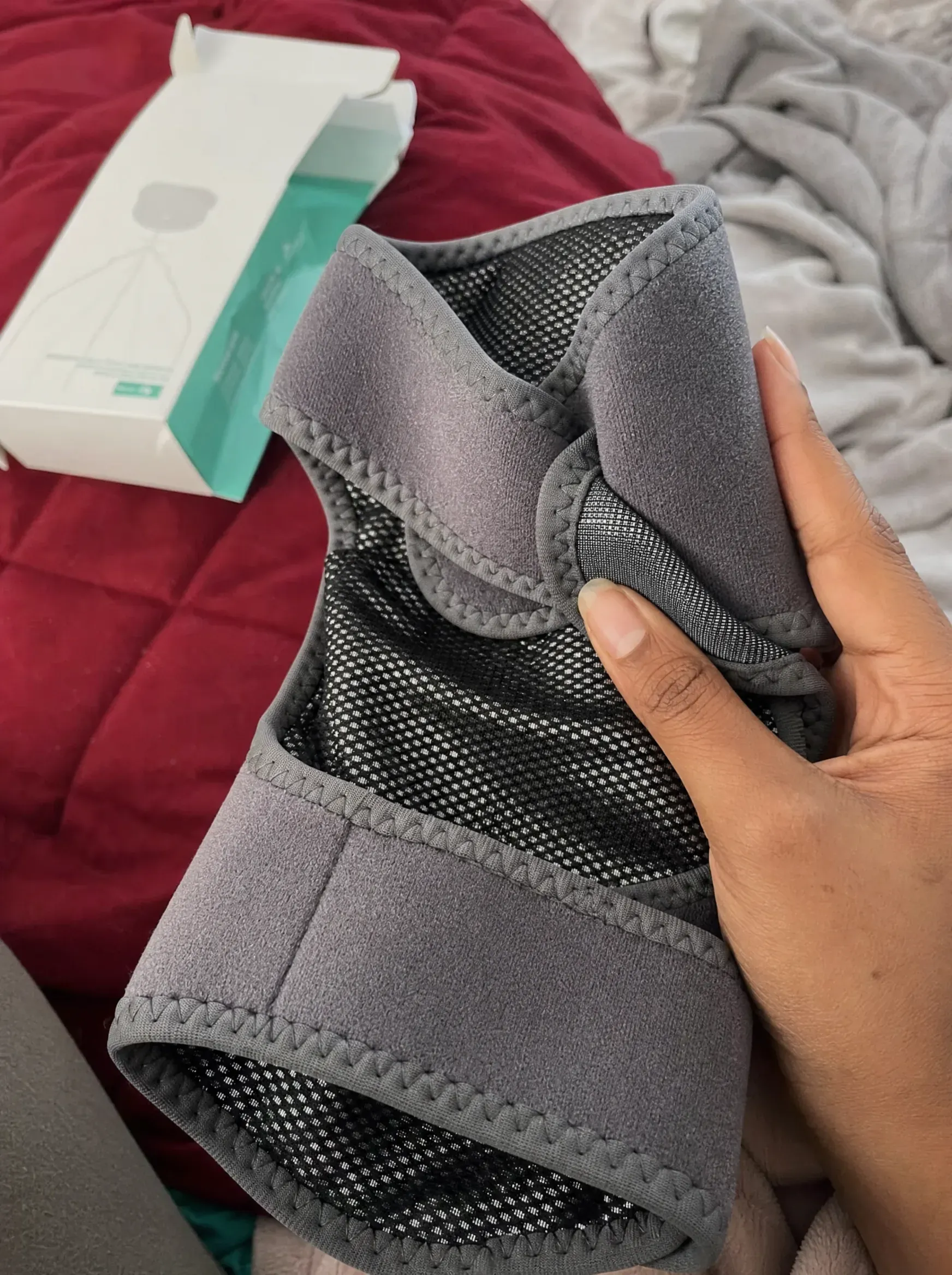 An older customer at home smiling after using the ReliefMD Knee Massager
