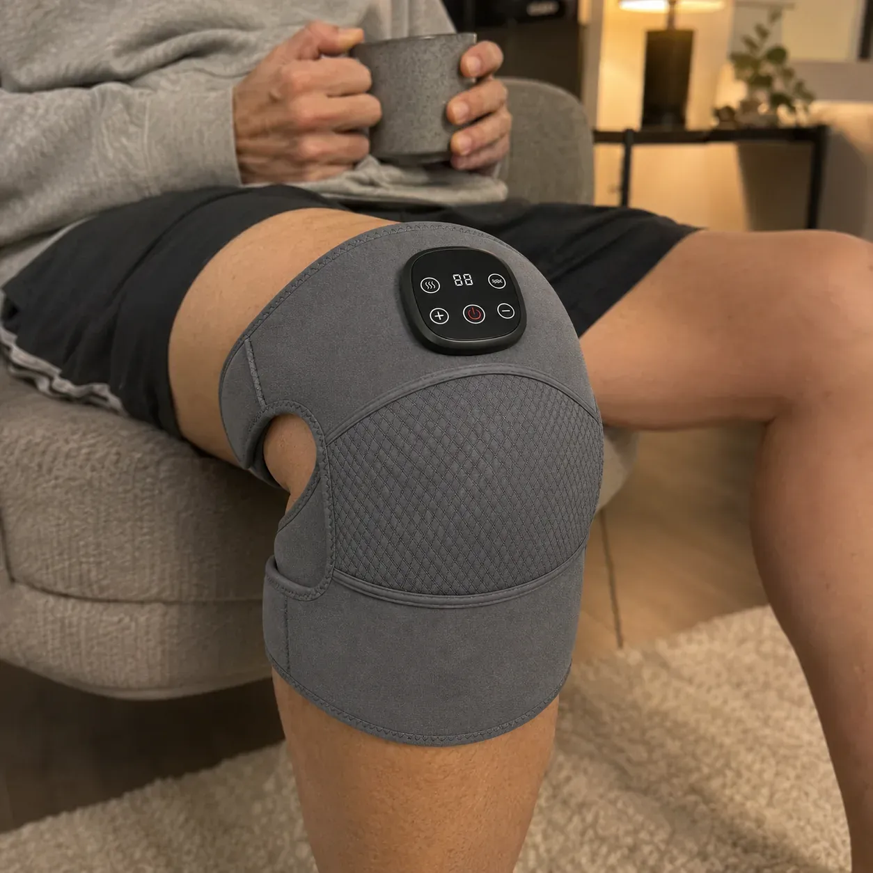 The ReliefMD Knee Massager shown on a bare knee in a candid home setting